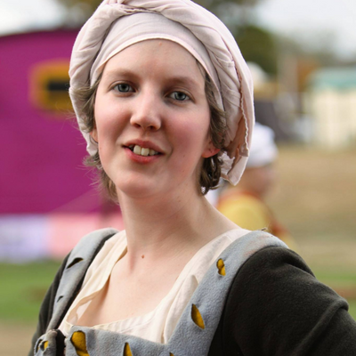A woman wearing a brown and blue wool dress.